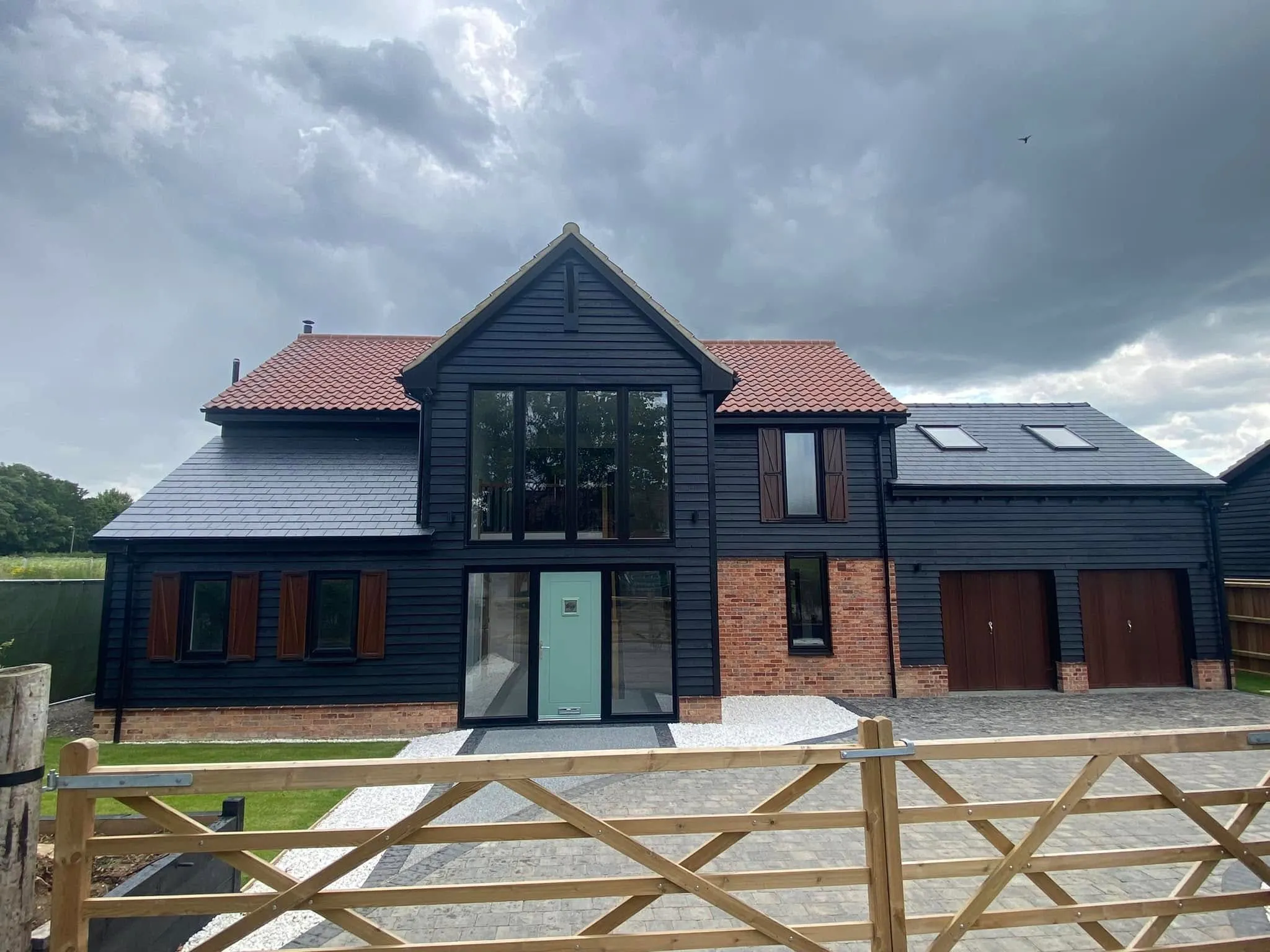Barn conversion with full-height feature windows and composite door