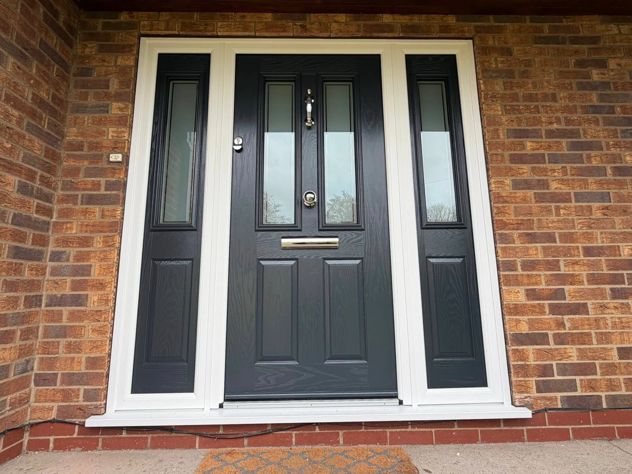 Black composite front door with glass side panels