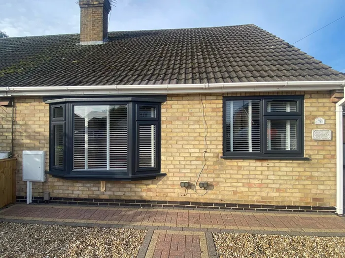 House after full window replacement - new anthracite bow bay window