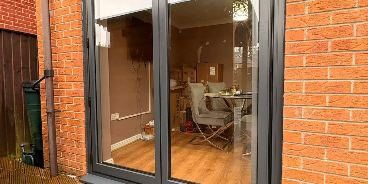 Anthracite grey patio doors opening onto timber decking