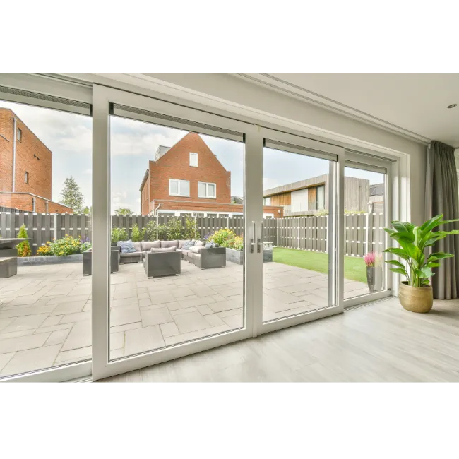 Wide sliding patio doors viewed from inside, opening onto a garden and patio