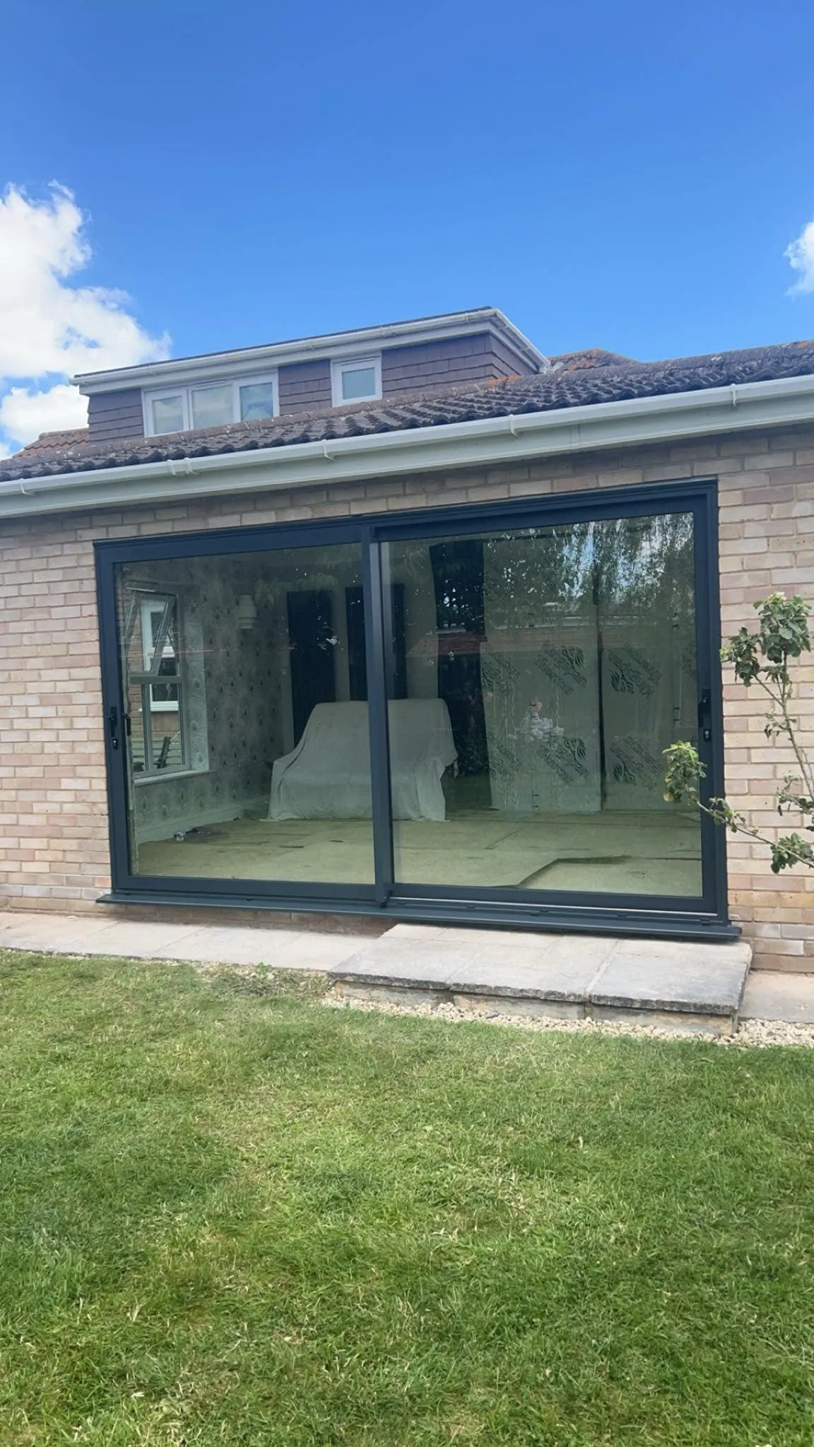 Anthracite grey sliding patio doors overlooking a garden