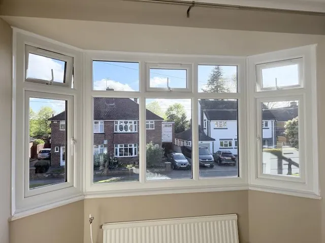 The same bay window after replacement, with clear A-rated glass and top-opening vents